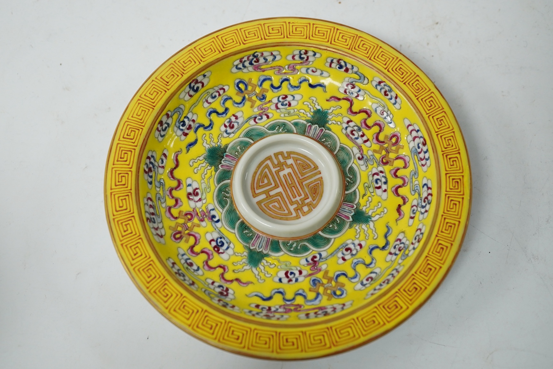 A Chinese porcelain yellow-ground tea cup and saucer, 13cm diameter. Condition - good